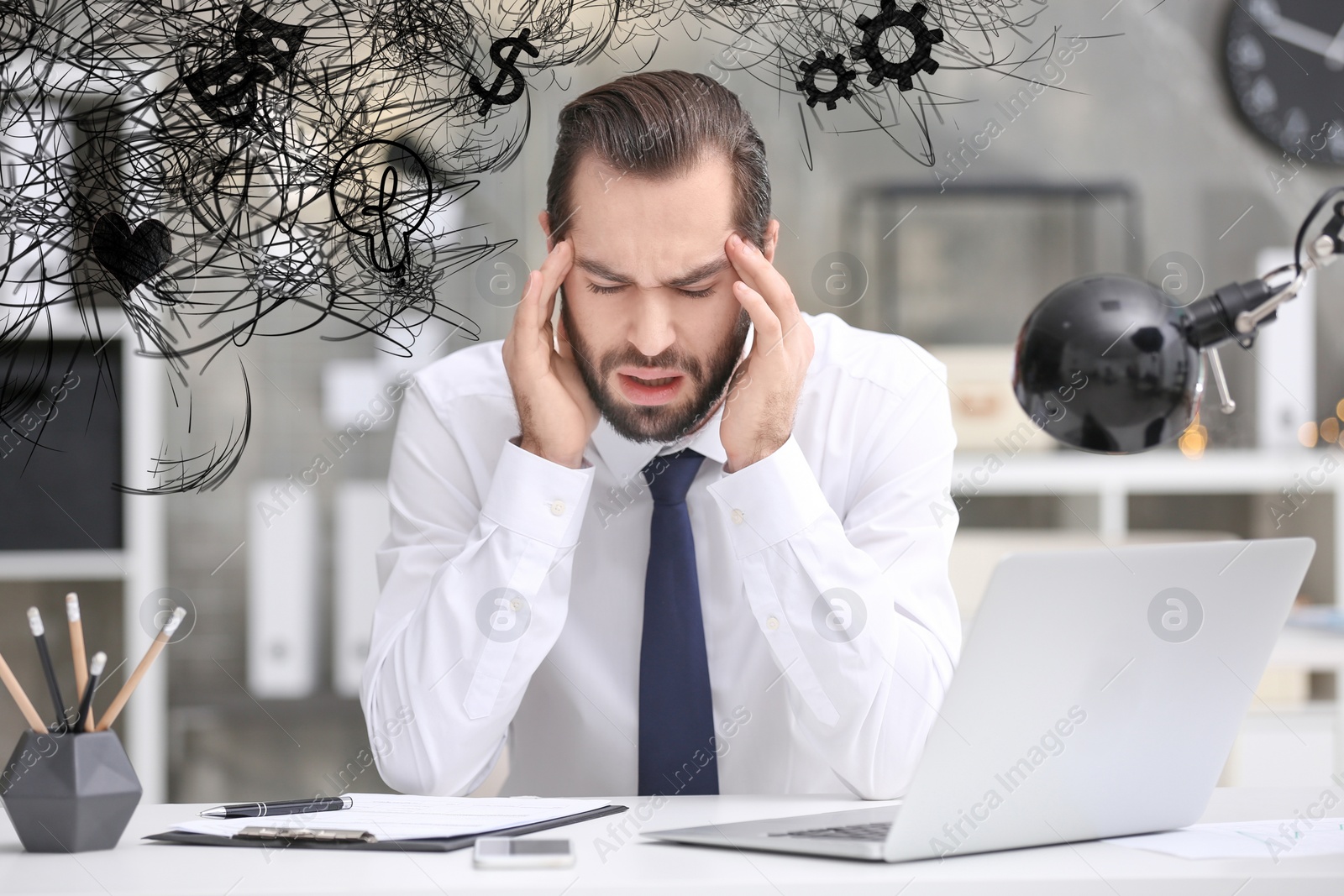 Image of Stressed man with mess in his head in office