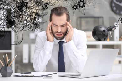 Image of Stressed man with mess in his head in office