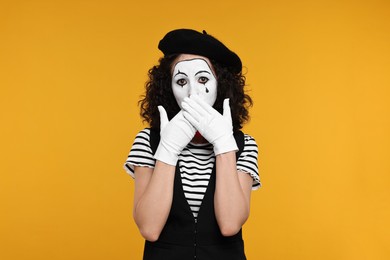 Photo of Funny mine with beret posing on orange background