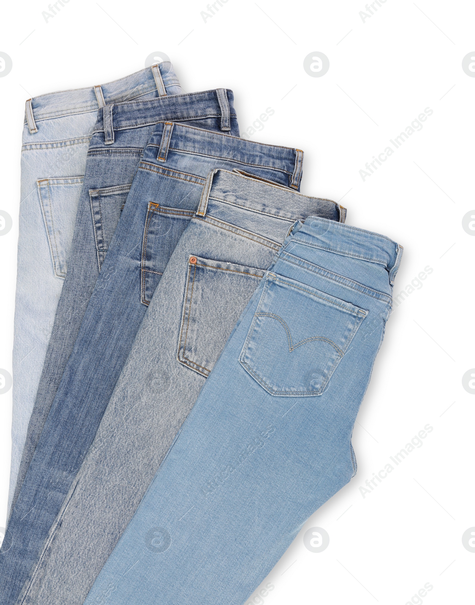 Photo of Different stylish jeans isolated on white, top view