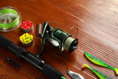 Photo of Fishing tackle on wooden table, space for text
