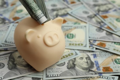 Photo of Money exchange. Dollar banknotes and piggy bank, closeup