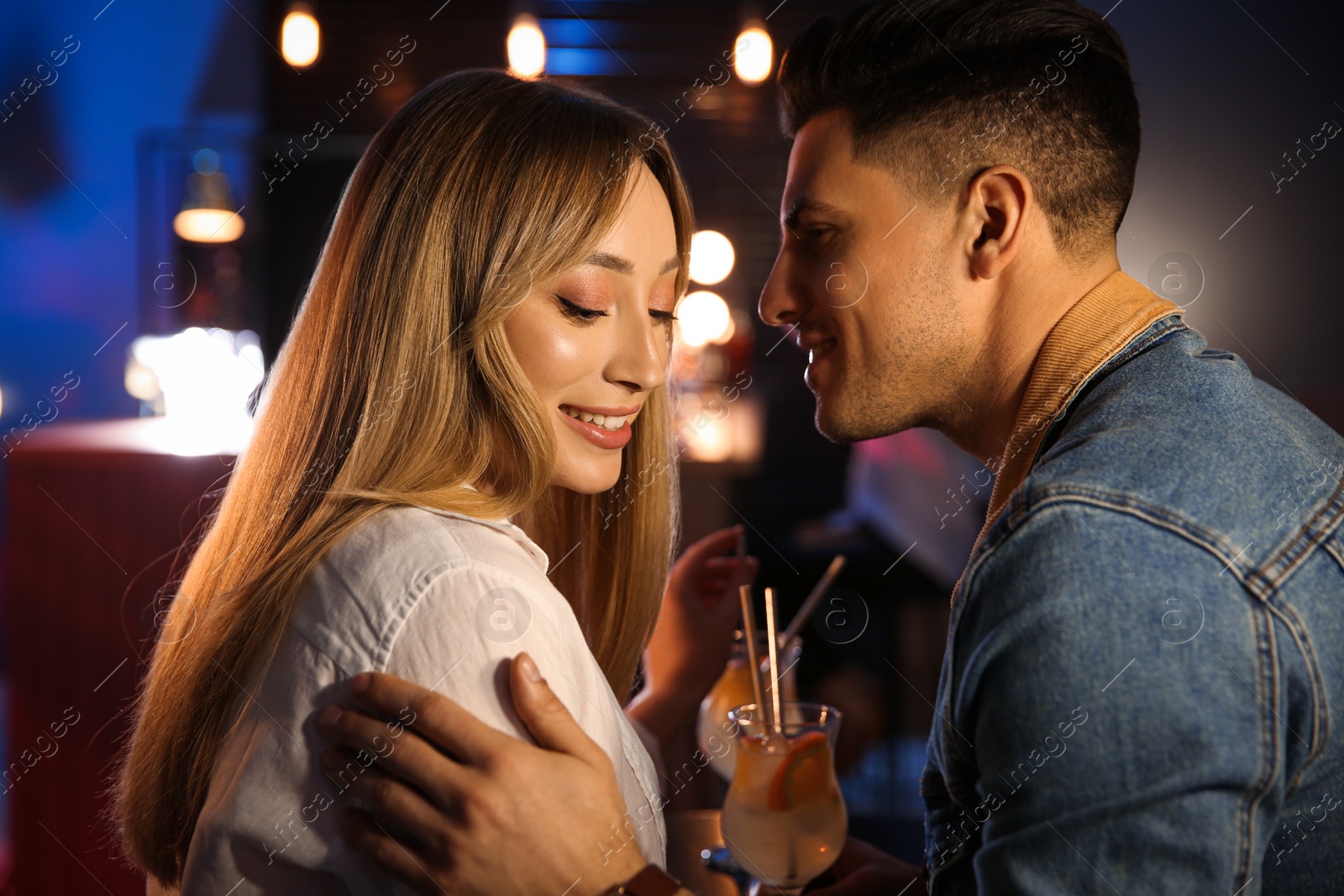 Photo of Man and woman flirting with each other in bar