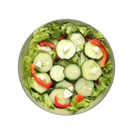 Photo of Delicious salad with cucumbers, red bell pepper and feta cheese in bowl isolated on white, top view