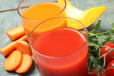 Delicious vegetable juices and fresh ingredients on table, closeup