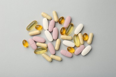 Different vitamin pills on light grey background, top view. Health supplement