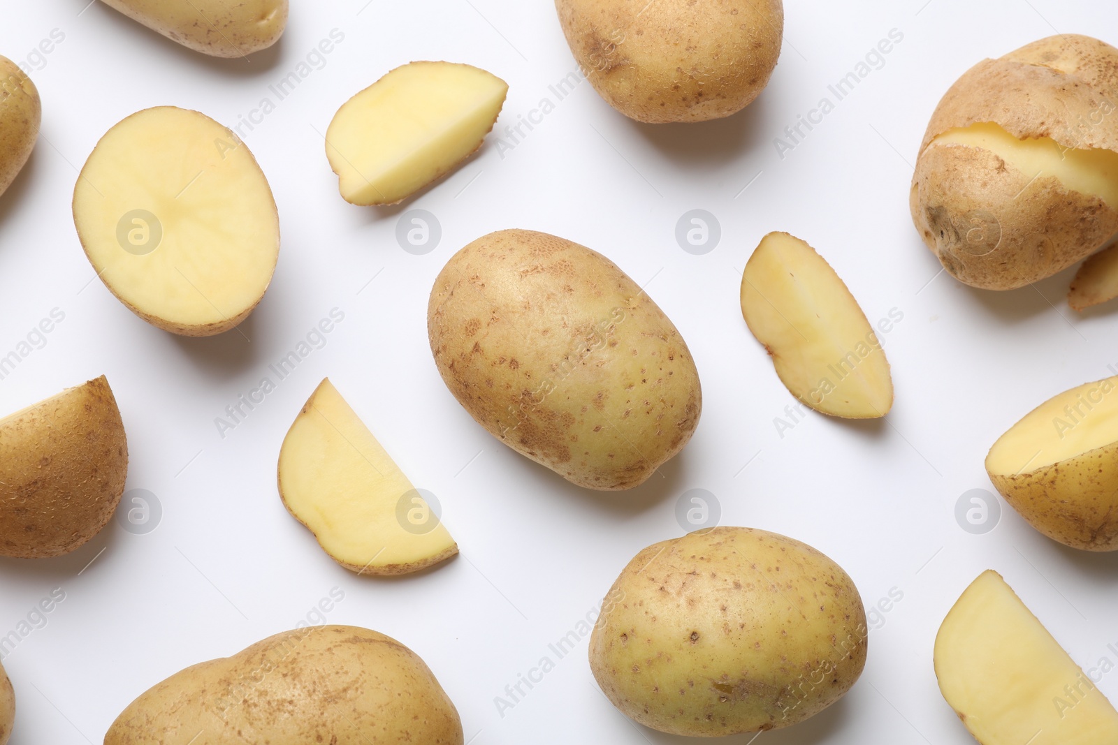 Photo of Fresh raw potatoes on white background, flat lay