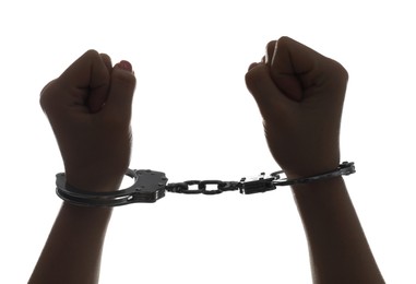 Photo of Freedom concept. Woman with handcuffs on white background, closeup