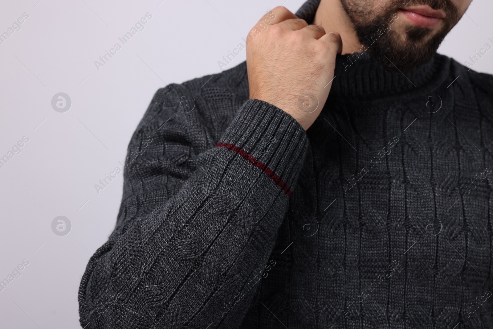 Photo of Man in stylish sweater on white background, closeup