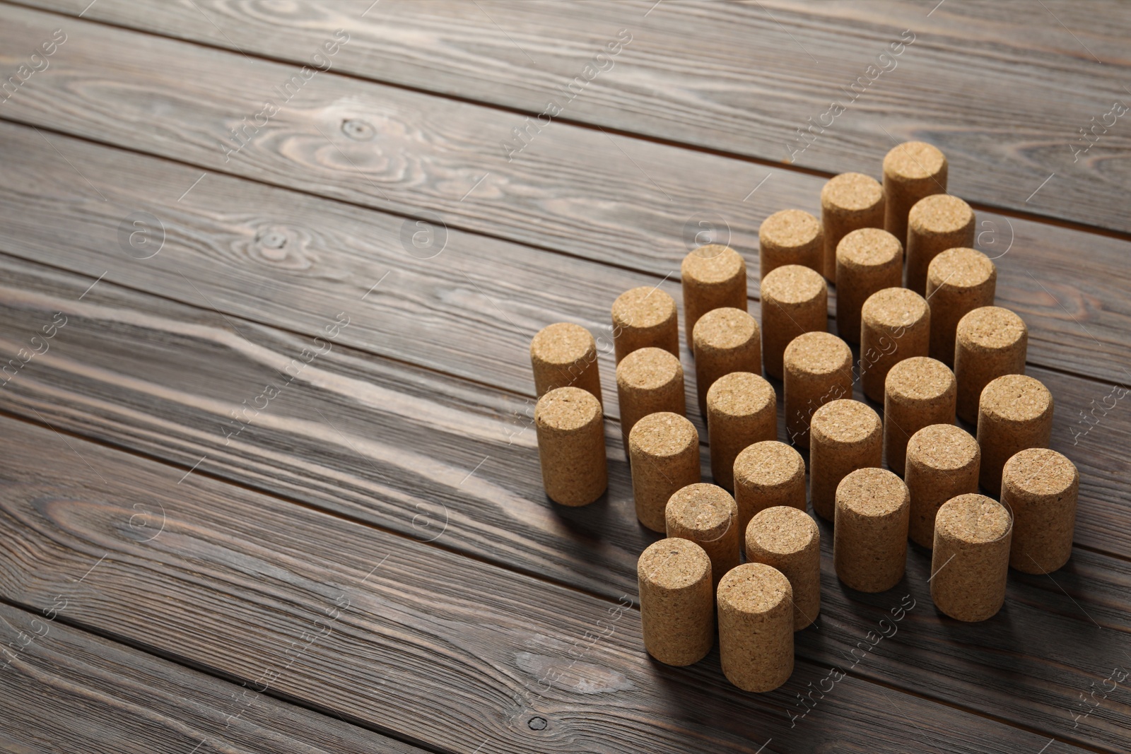 Photo of Christmas tree made of wine corks on wooden table. Space for text