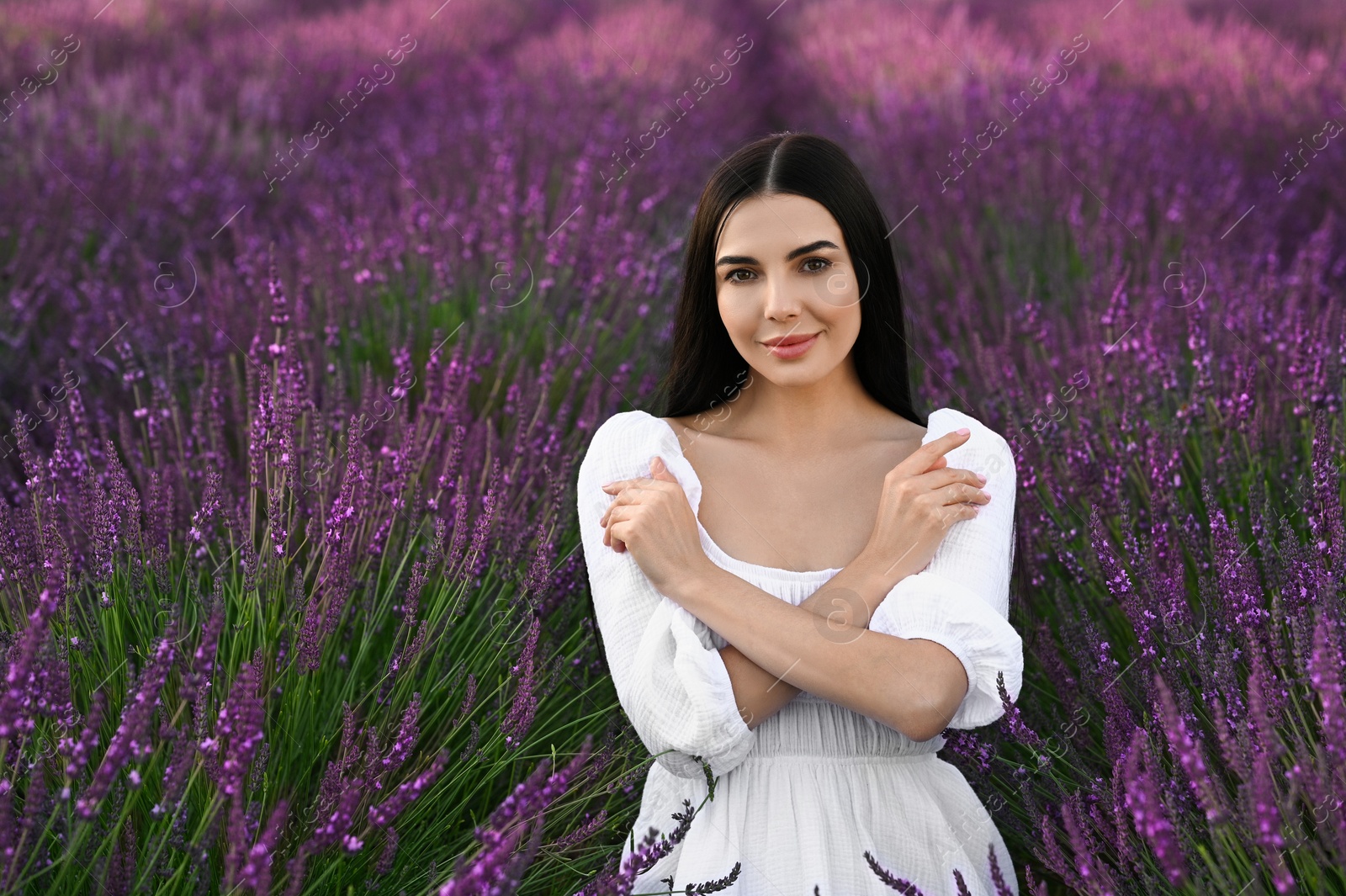 Photo of Portrait of beautiful young woman in lavender field