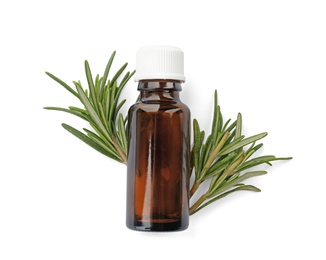 Photo of Bottle with rosemary essential oil and fresh herb on white background
