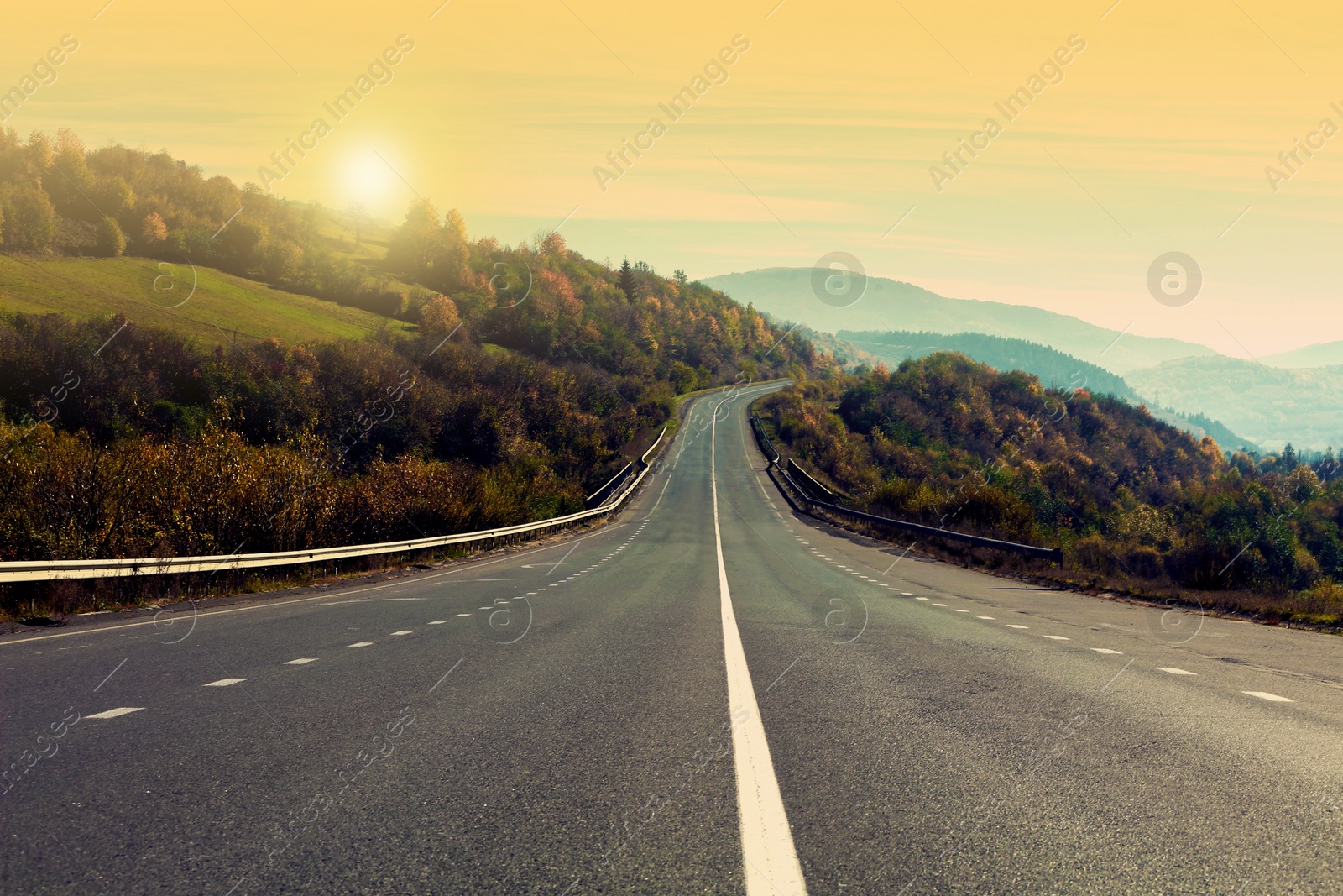 Image of Road trip. Beautiful view of asphalt highway at sunset 