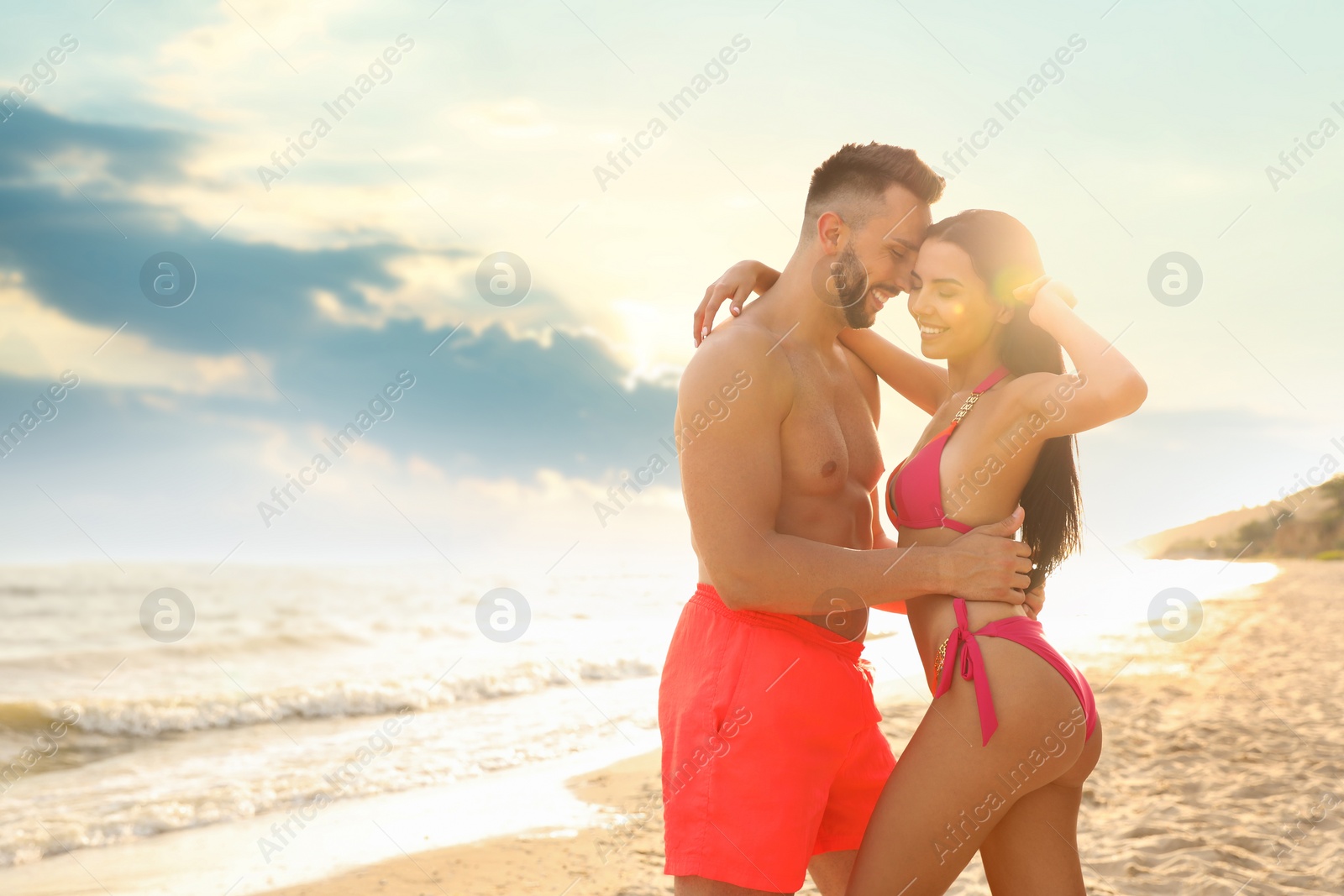 Photo of Happy young couple on beach on sunny day