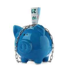 Photo of Piggy bank with steel chain and banknotes isolated on white. Money safety concept