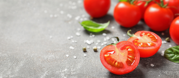 Image of Fresh cherry tomatoes on grey table, space for text. Banner design 