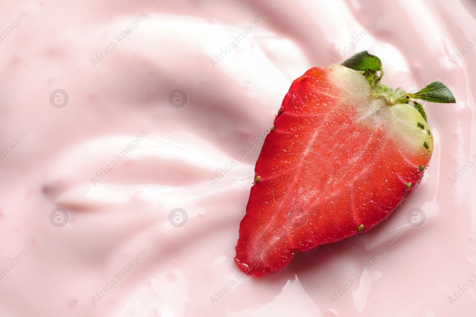Photo of Tasty fresh yogurt with strawberry, closeup