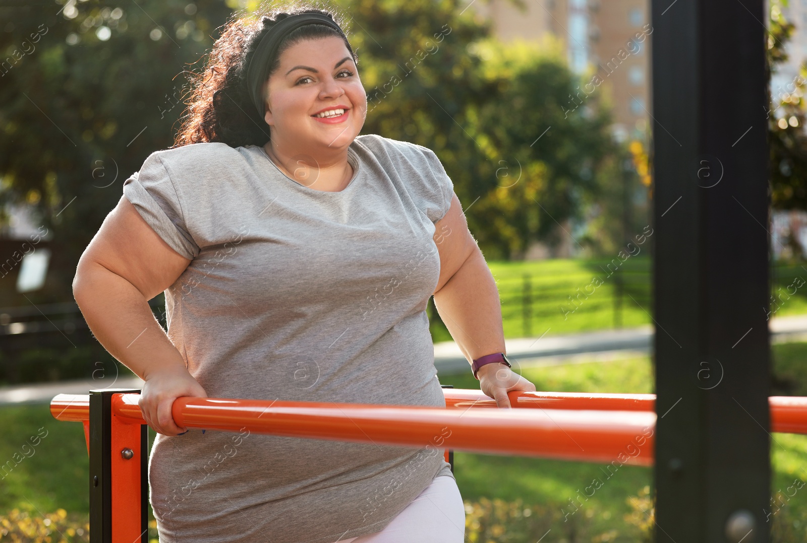 Photo of Beautiful overweight woman training on sports ground