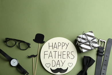 Photo of Flat lay composition with greeting card on green background, space for text. Happy Father's Day