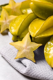 Cut and whole carambolas on table, closeup