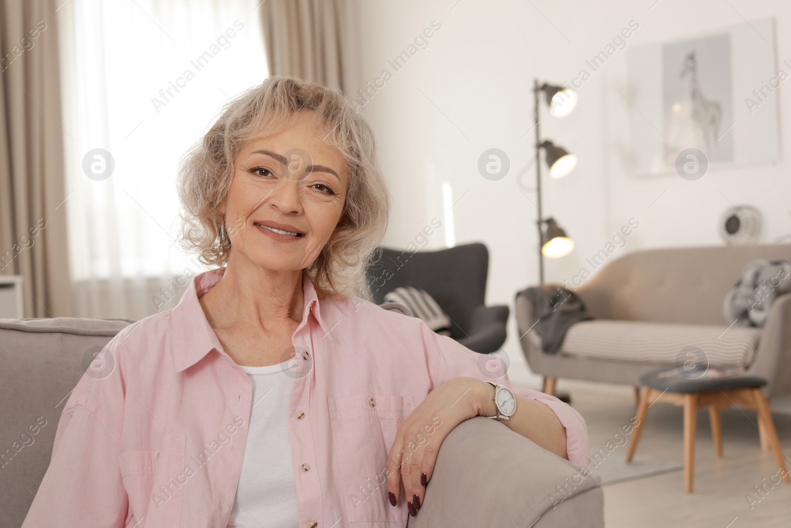 Photo of Portrait of mature woman in living room