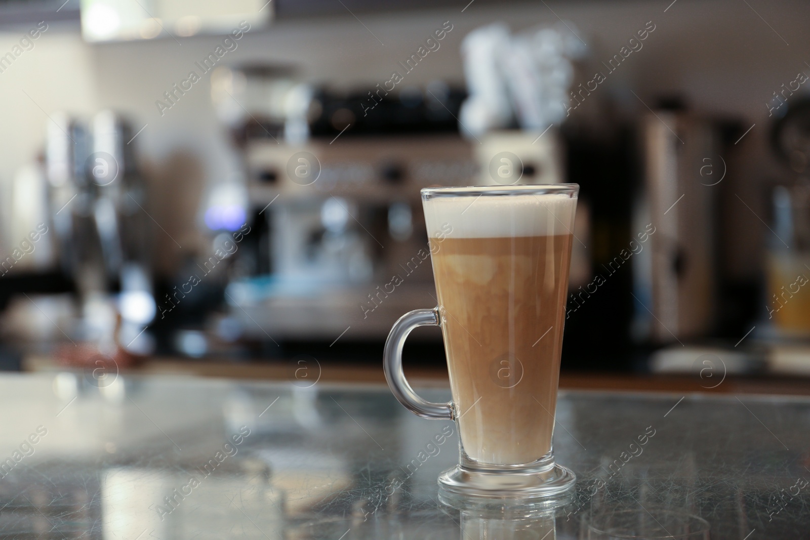 Photo of Glass with delicious coffee on countertop in cafe indoors, space for text