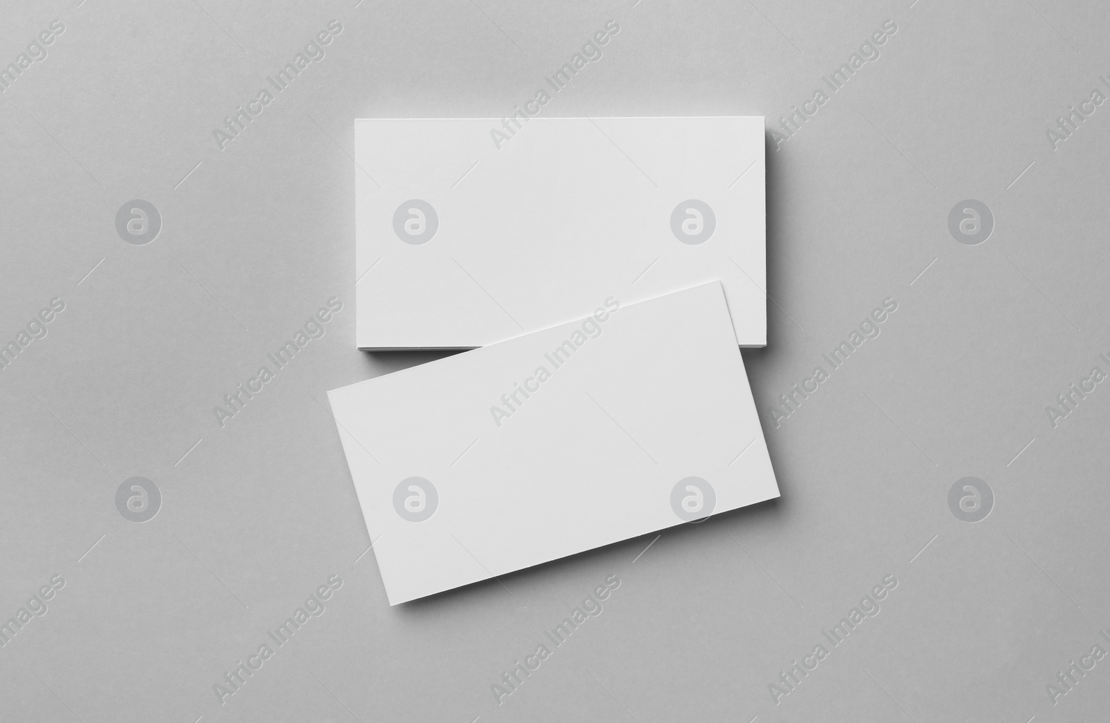 Photo of Blank business cards on light grey background, flat lay. Mockup for design