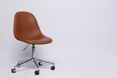 Comfortable office chair on white background, space for text