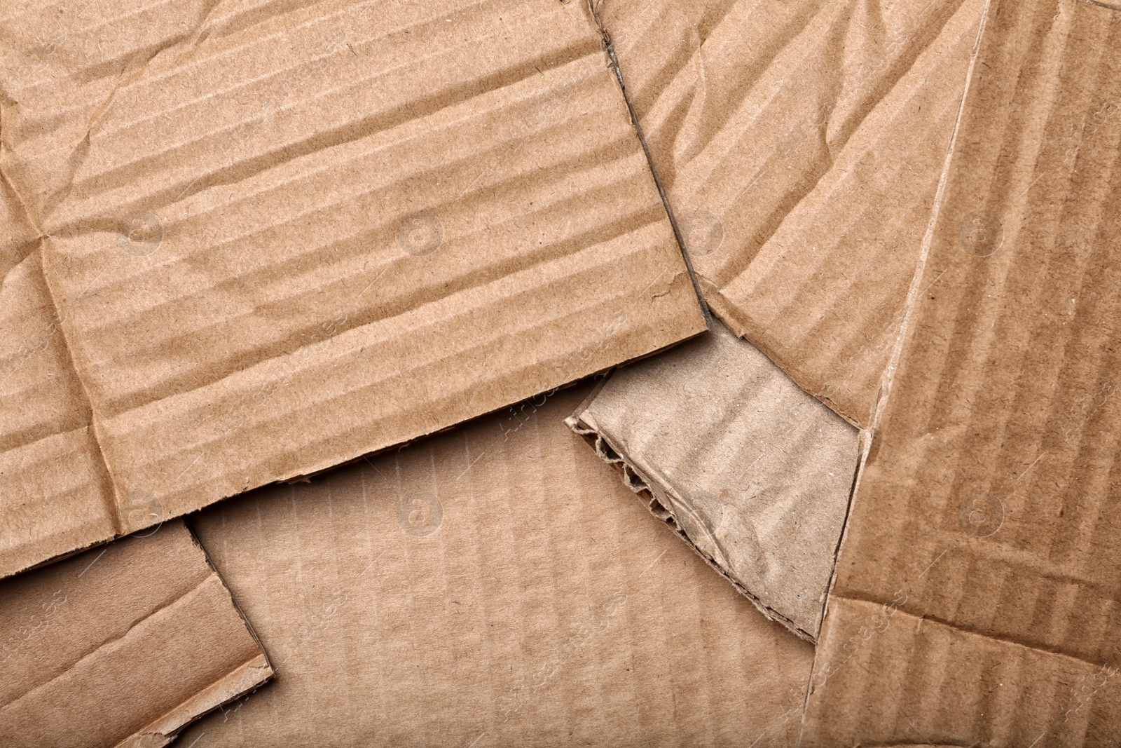 Photo of Pieces of cardboard as background, top view. Recycling problem