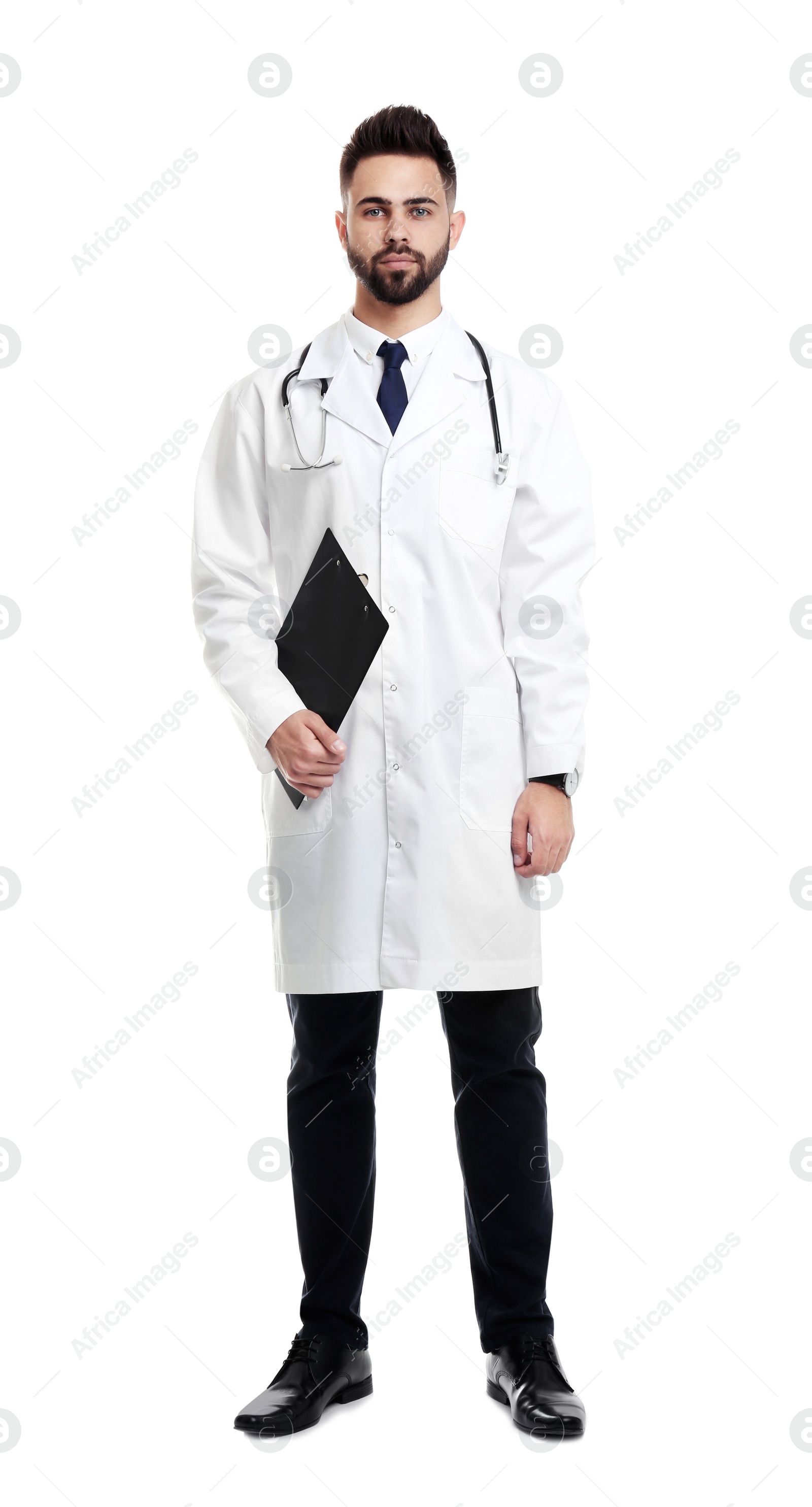 Photo of Young male doctor in uniform with clipboard isolated on white