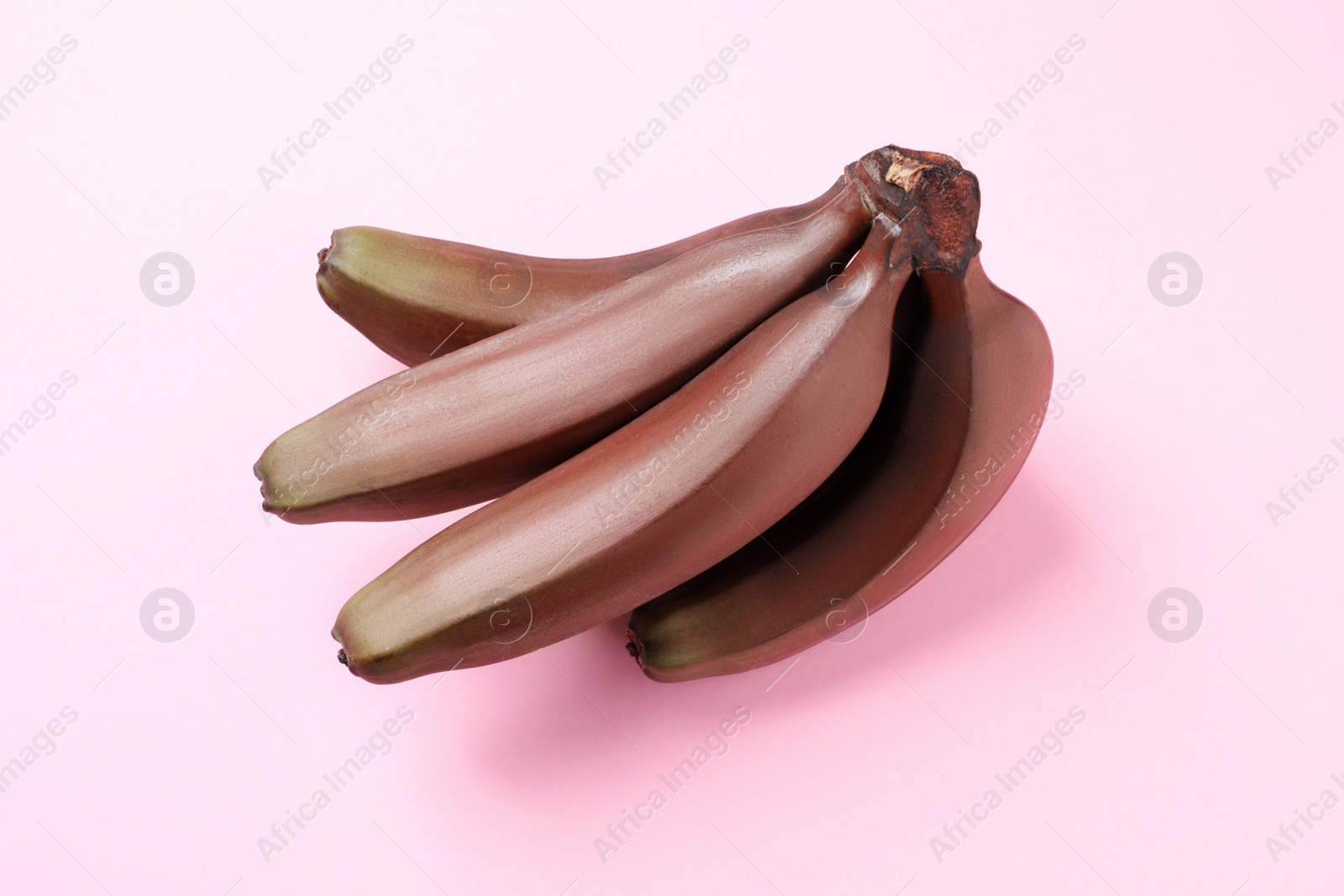 Photo of Tasty red baby bananas on pink background, top view