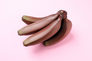 Tasty red baby bananas on pink background, top view