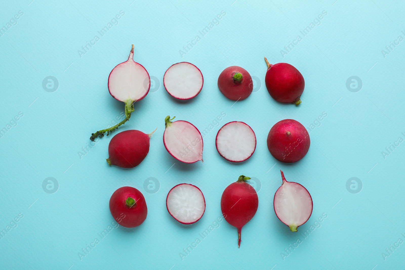 Photo of Fresh ripe radish on light blue background, flat lay