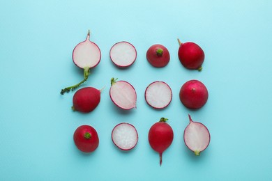 Photo of Fresh ripe radish on light blue background, flat lay