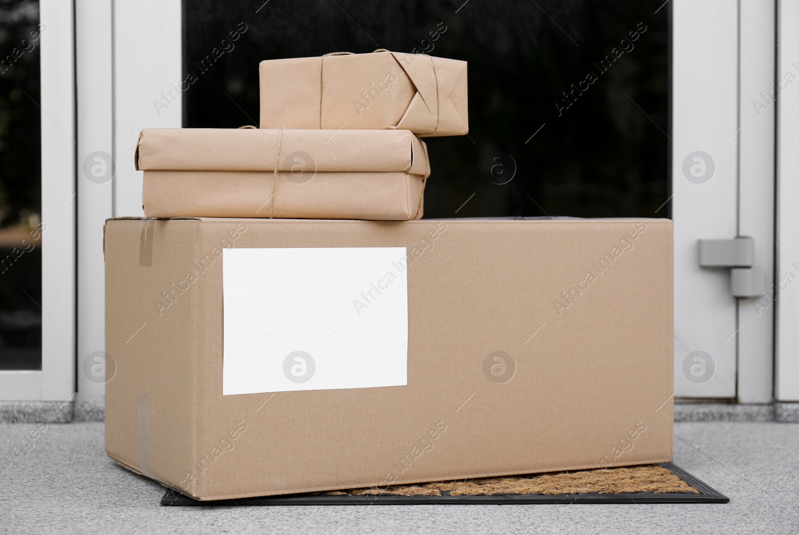 Photo of Delivered parcels on door mat near entrance