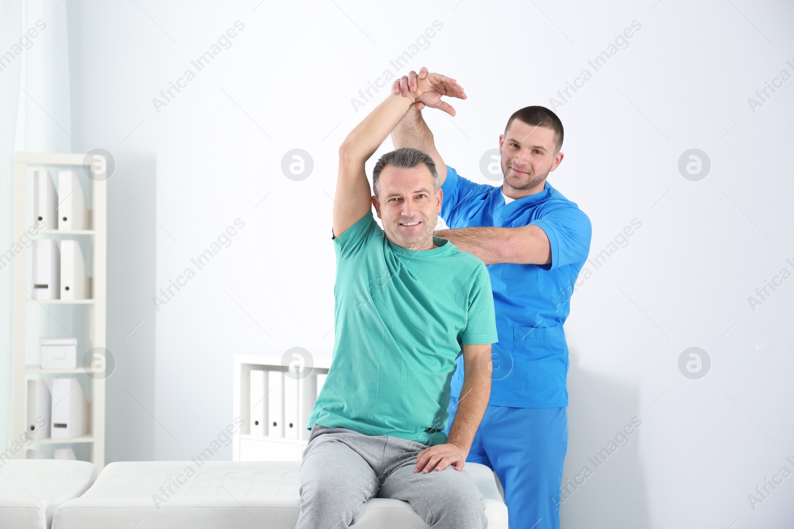 Photo of Doctor working with patient in hospital. Rehabilitation physiotherapy