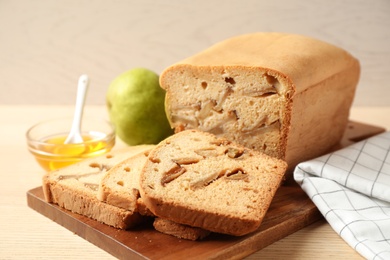 Photo of Composition with tasty pear bread on wooden table, closeup. Homemade cake