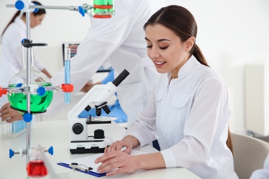 Photo of Medical student working at table in scientific laboratory