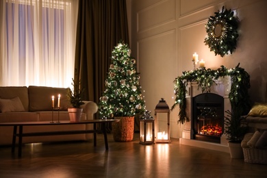 Beautiful room interior with fireplace and Christmas decor in evening