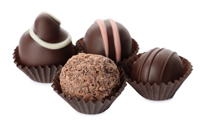 Many different delicious chocolate truffles on white background