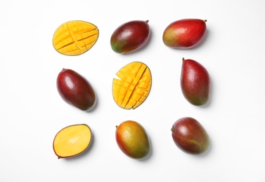 Photo of Tropical cut and whole mango fruits isolated on white, flat lay