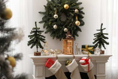 Photo of Fireplace in room with Christmas decorations. Interior design