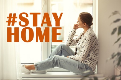 Image of Hashtag Stayhome - protective measure during coronavirus pandemic. Young woman sitting on window sill indoors