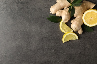 Photo of Fresh lemon and ginger on grey table, flat lay. Space for text