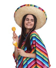 Young woman in Mexican sombrero hat and poncho with maracas on white background