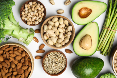 Photo of Different products rich in vitamin E on white background, flat lay