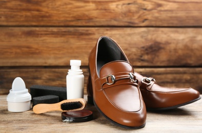 Shoe care accessories and footwear on wooden table