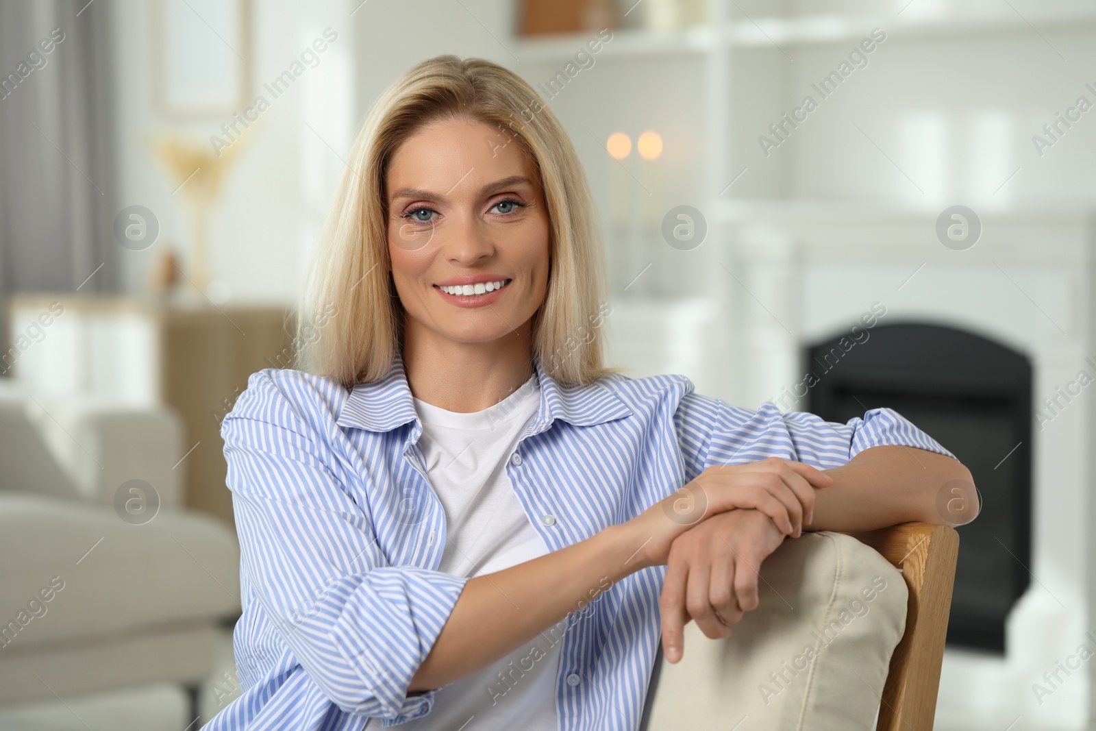 Photo of Portrait of smiling middle aged woman with blonde hair at home