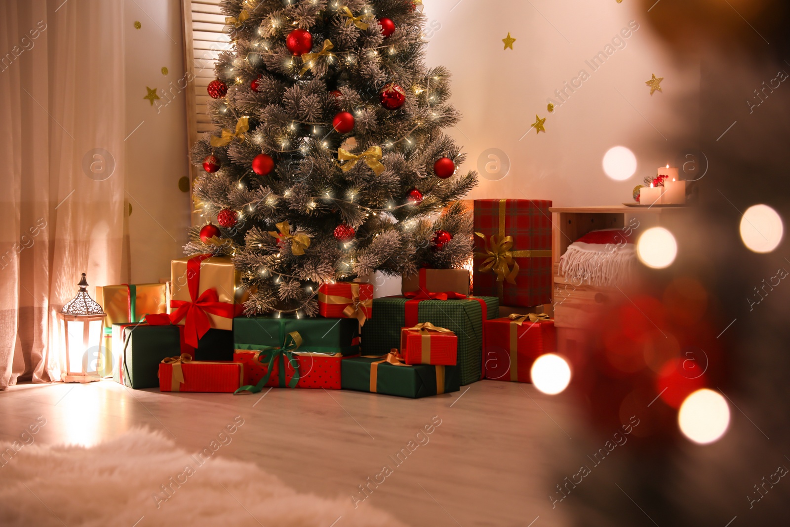 Photo of Stylish room interior with beautiful Christmas tree and gift boxes