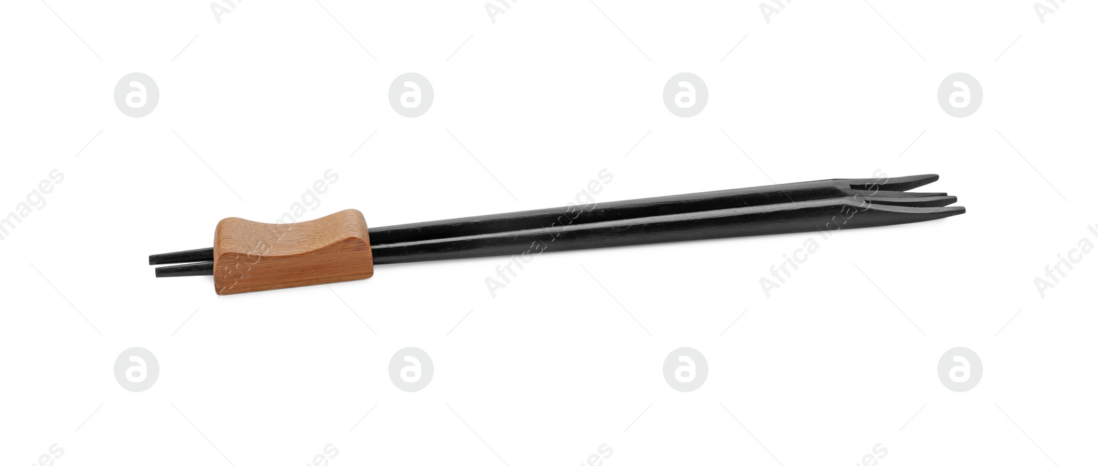 Photo of Pair of black chopsticks with rest isolated on white